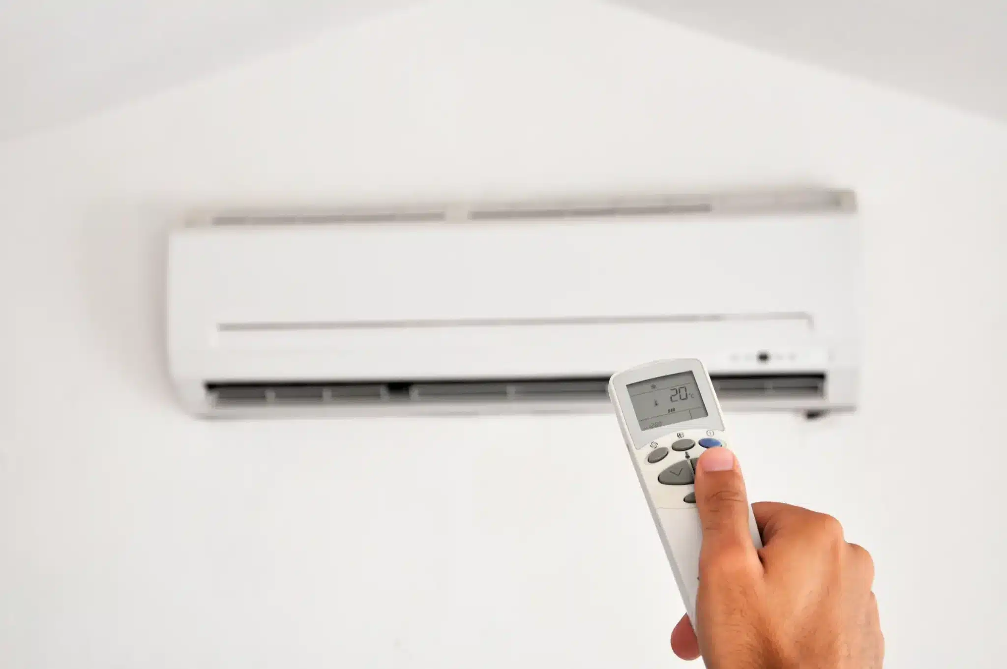 What Is the Major Advantage of Mini-Split Air-Conditioning Systems? An image of someone pointing a remote at a mini-split.